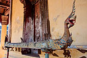 Vientiane, Laos - Wat Si Saket, the wooden trough in the shape of a Naga, used for the  ceremonial cleaning of Buddha statue. 